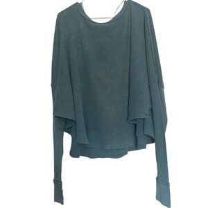 FREE PEOPLE teal green long sleeve thermal flowy top with a loose fit